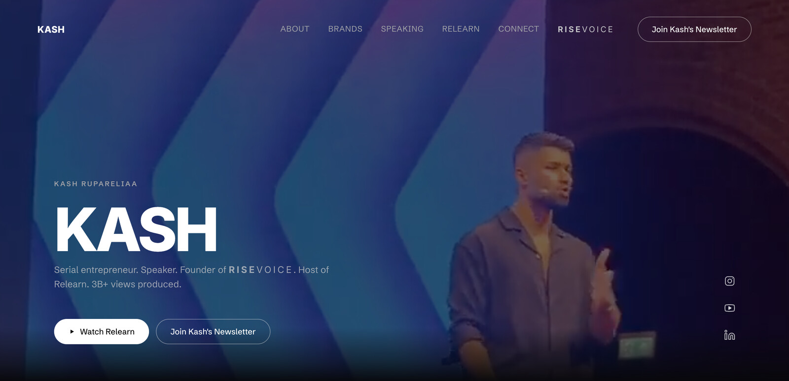 kashrupareliaa.me — homepage hero: Kash on stage, black and white system, one wordmark